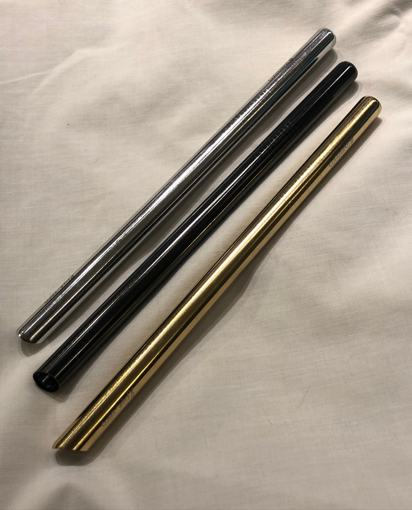 three stainless steel bubble tea straws with a tapered end in silver, black, and gold colour